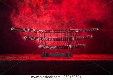 Three Swords On Stand, Red Smoke Behind