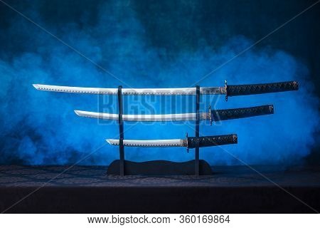 Three Swords On A Stand With Exposed Blades