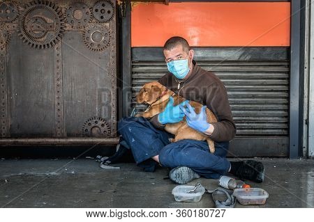 Hungry Sick Homeless Beggar Man On The Street With His Dog Begging For Money And Food To Eat Wearing