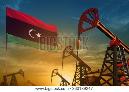 Libya Oil Industry Concept, Industrial Illustration. Fluttering Libya Flag And Oil Wells On The Blue