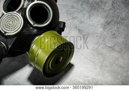 Gas Mask On A Black Stone Background, Protection From Dangerous Infection.