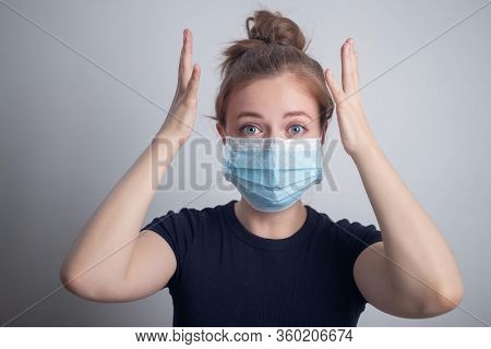 Young Caucasian Woman Girl Wearing A Mask, Looks Panicky, Worried Or Nervous