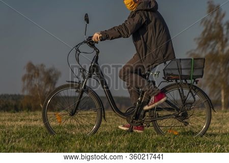 Young Man On Black Electric Bike In Spring Color Evening