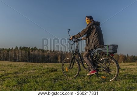 Young Man On Black Electric Bike In Spring Color Evening