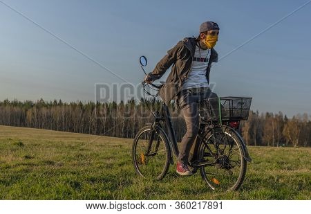Young Man On Black Electric Bike In Spring Color Evening