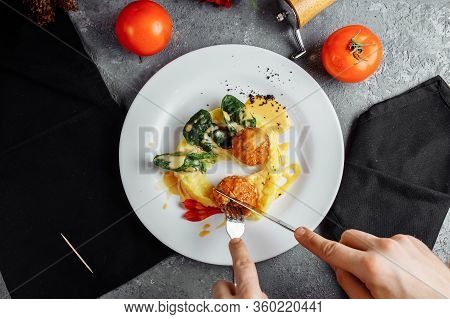 Cheese Balls In The Sauce. With Fork, Knife In Hand