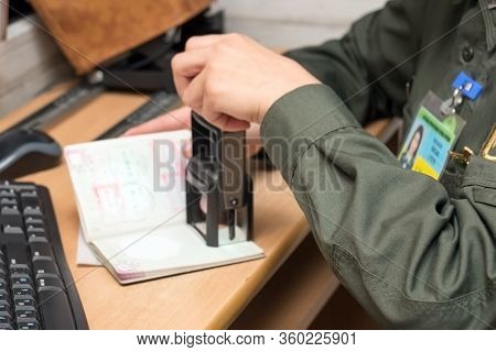 Close-up Of Putting A Mark In A Passport Document By A Representative Of The Border Service During B