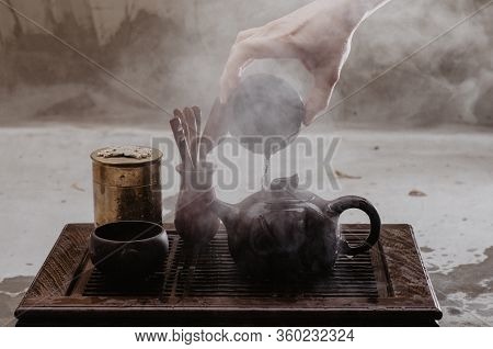 Cropped Shot Of Woman Pouring Tea In Traditional Chinese Teaware