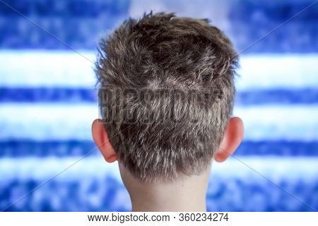 Boy watching television with noise, shallow focus on hair