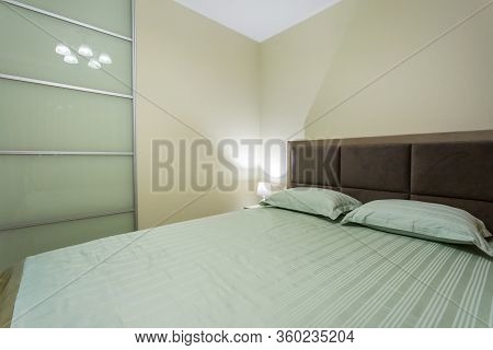 Masterbed In Interior Of The Modern Luxure Bedroom In Studio Apartments In Light Color Style