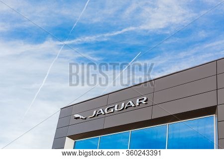 Jaguar Brand Logo On Bright Blue Sky Background Located On Its Dealer Office Building In Lyon, Franc
