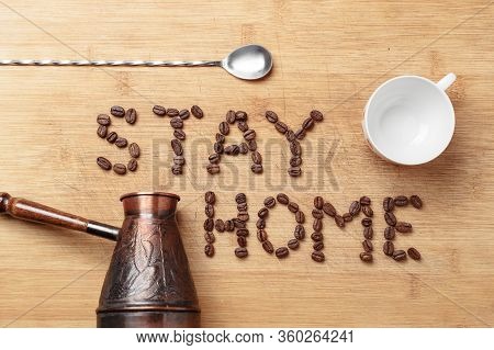 Roasted Coffee Beans, A Twisted Spoon, A Copper Cezva And A White Porcelain Cup