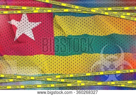 Togo Flag And Covid-19 Quarantine Yellow Tape. Coronavirus Or 2019-ncov Virus Concept