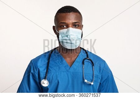 Protect Yourself. Portrait Of Confident Black Doctor In Face Mask Over White Studio Background, Copy