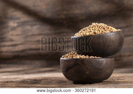 Organic Yellow Mustard Seeds In Wooden Bowls - Sinapis Alba