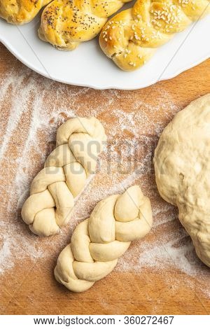 Unbaked braided bun dough. Raw dough. Unbaked buns. Top view.