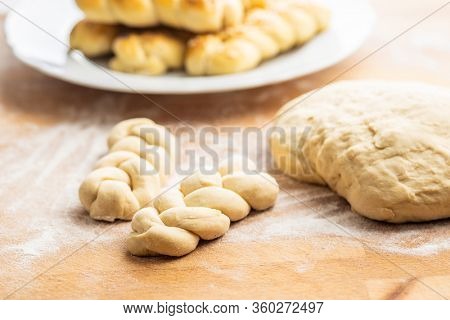 Unbaked braided bun dough. Raw dough. Unbaked buns.
