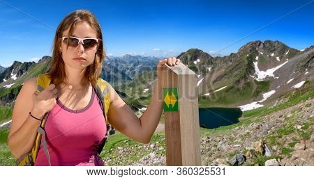 A Young Woman Hiker And Lake Oncet In The French Mountains Pyrenees