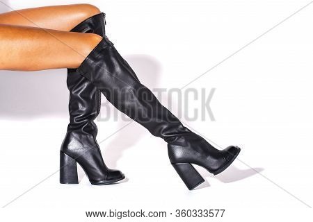 Black Hessian Boots On The Feet Of A Model On A White Background With Shadows. Jackboots. Studio Sho