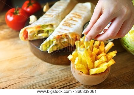 Home Made Shawarma. French Fries And Shawarma On The Rustic Wooden Table. Hand Taking A Fried Potato