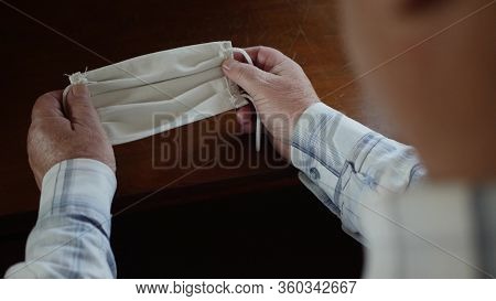 Hands Of An Poor Old Man With A Medical Mask.