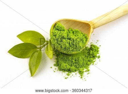 Dry Green Tea Powder Matcha Tea With A Wooden Spoon And Whole Leaves, Isolate On A White Background.