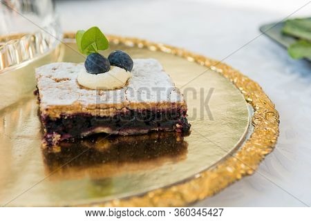 Delicious Blueberry Cake Sprinkled With Ground Sugar On Gold Plate.