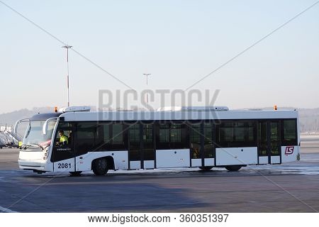 Krakow, Poland 20.12.2019: White Bus Cobus Is Driving Along The Runway At The Airport. Organization 