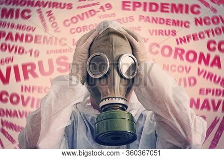 A Man With A Mask On Gas Mask And Protective Anti- Plague Suit, Scared By The News Of The Coronaviru