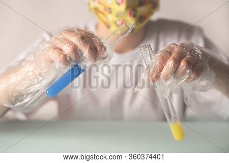 A Child In A White T-shirt In The Laboratory Is Studying Chemistry . Young Scientists In Protective 