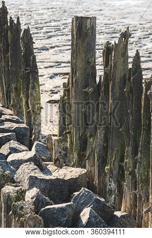 Old Wave Beaten Pylons Which Were Once A Pier Now Become A Beautiful Scene Of Nautical Historic Visi