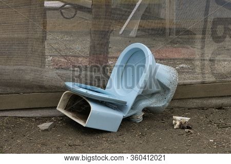 The Old Toilet Bowl Was Thrown Out At A Construction Site After Major Repairs Of A Multi-story Munic