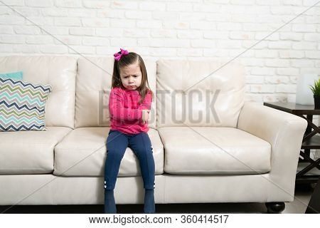 Cute Caucasian 3 Year Old With Arms Crossed And Frowning Looking Upsed And Angry At Home