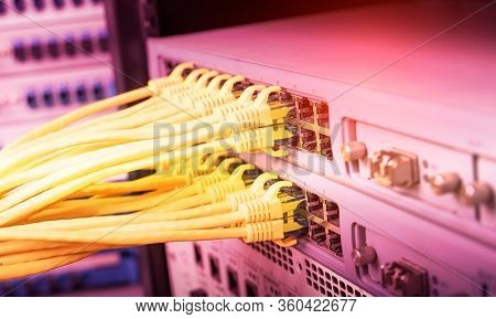 yellow network cable in switch and firewall in cloud computing data center server rack