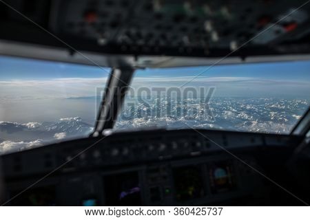 Commercial airliner airplane cockpit during flight with great weather below
