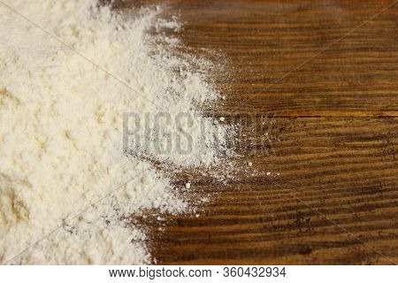 Blurry Image Of White Flour On Brown Wooden Background.  Abstract Food Backdrop. White Powder Textur