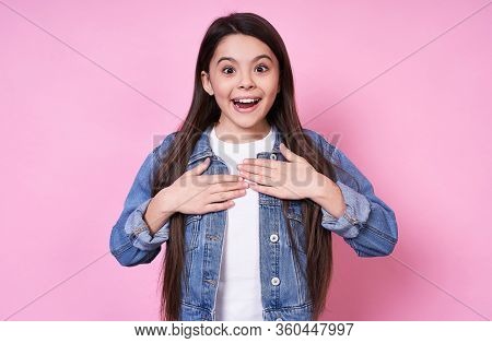Sweet Young Funny Emotional Caucasian Girl Child Long-haired Brunette. Smiles Broadly, Does Not Beli