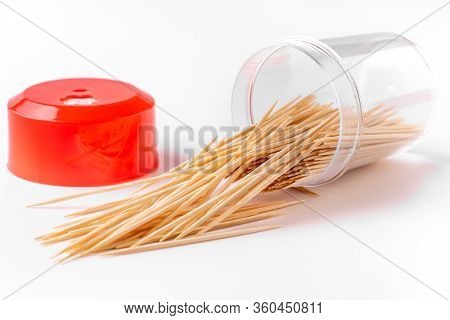 Bottle With Toothpicks On A White Background. The Toothpick Falls, Crumbles, Spills. Lots Of Scatter