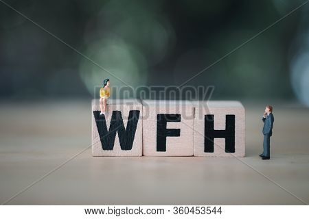 Miniature People Sit On Wood Blocks Of Wfh Mean (working From Home) With Nature Background