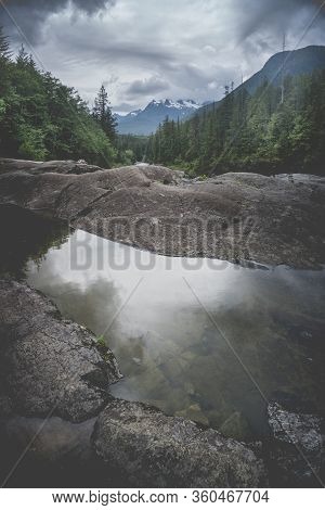 The Beauty Of Wally Creek Pullout. Forest, Wild River, Rocks And Trees On Vancouver Island In Canada