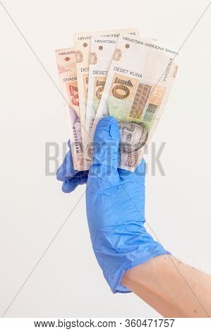 Croatian Kuna Banknotes In Hand In Surgical Gloves. Hrk Banknotes. Covid-19 Coronavirus Outbreak. Co