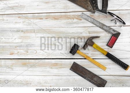 The Equipment For Woodworking Is Organized Neatly On The Wood Floor. Ordered As Follows, Hand Saw, D