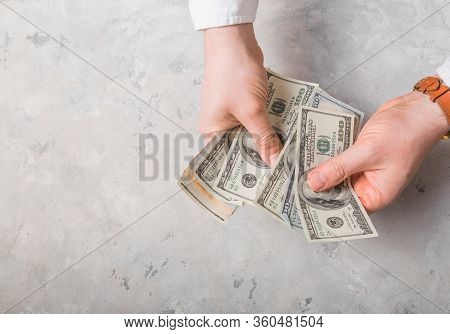 Male Hands Count Cash Money In The Office. Close Up Of Man Hands Count Dollar Bills. Starting Invest