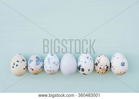 Beautiful Colorful Quail Eggs On Pastel Light Blue Background.