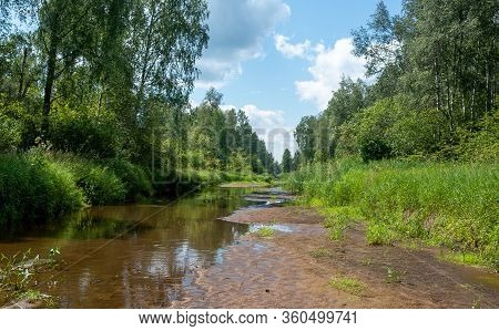 Shallow Riverbed Of A Small Forest River In The Middle Of Russia In The Hot Dry Summer.