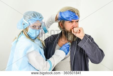 Diagnosis Of Pneumonia. Doctor Protective Equipment Examines Patient Suspected Coronavirus Infection