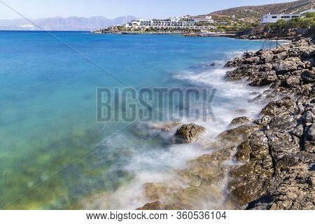 Waves Hitting The Rocks During Hot Summer Day In Greece