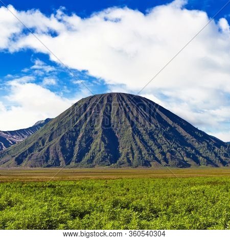 Volcano Against Blue Sky With Clouds. Bromo Tengger Semeru Natio