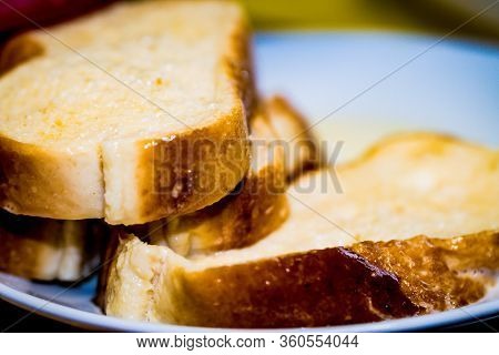 Putting Bread With Milk To Make A Typical Spanish Food, Torrijas.