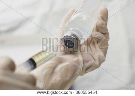 Anesthesiologist Doctors Hand Inject Syringe Into Normal Saline Solution (nss) Bottle,coronavirus Tr